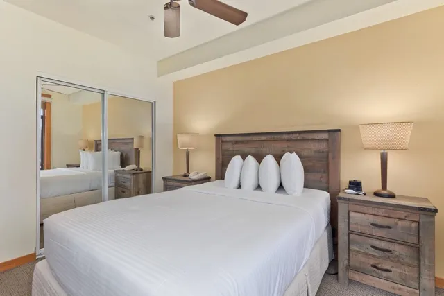 a bedroom with a bed and a lamp on table