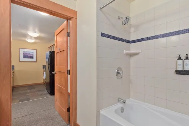 a bathroom with a tub a shower and a sink