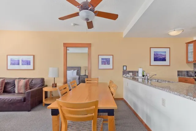 a living room with stainless steel appliances granite countertop couches a fireplace with wooden floor