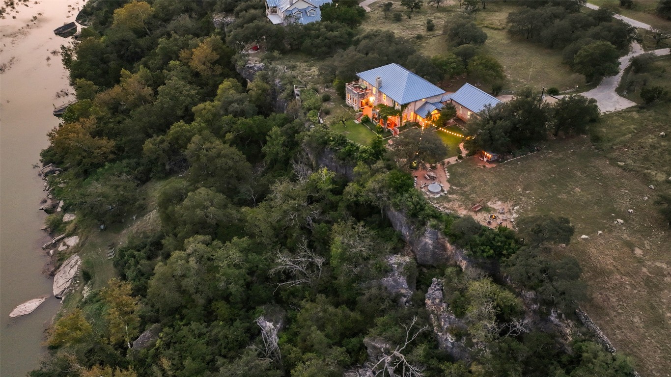 5229-5012 Hupedo Ranch Road Spicewood, TX 78669 - Photo 21 of 40 an aerial view of a house with a yard and trees