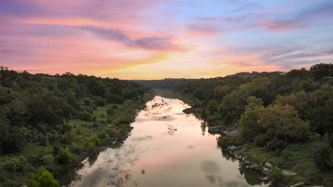 5229-5012 Hupedo Ranch Road Spicewood, TX 78669 - Photo 24 of 40 a view of a big yard with mountains in the background