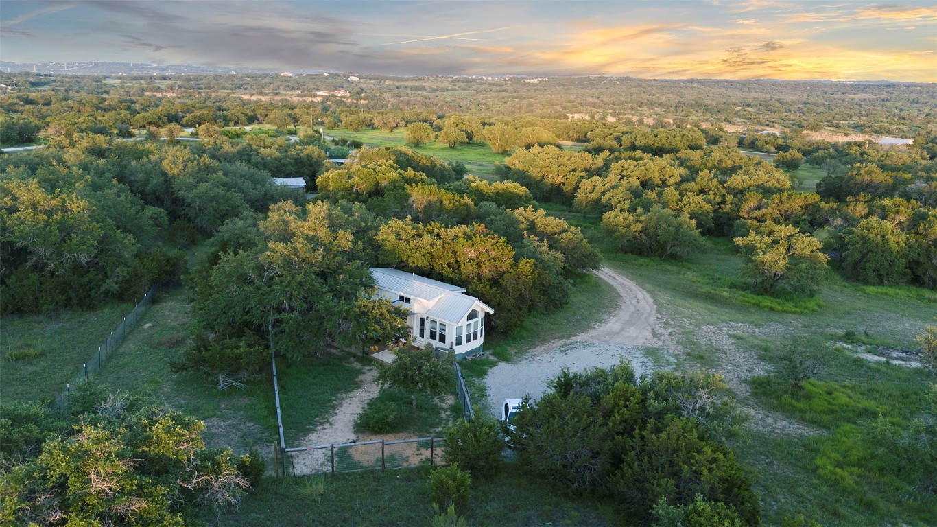 5229-5012 Hupedo Ranch Road Spicewood, TX 78669 - Photo 31 of 40 an aerial view of green landscape with trees houses and mountain view