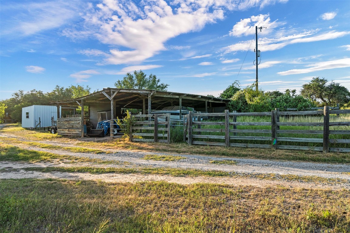 5229-5012 Hupedo Ranch Road Spicewood, TX 78669 - Photo 38 of 40 a front view of a house with a garden