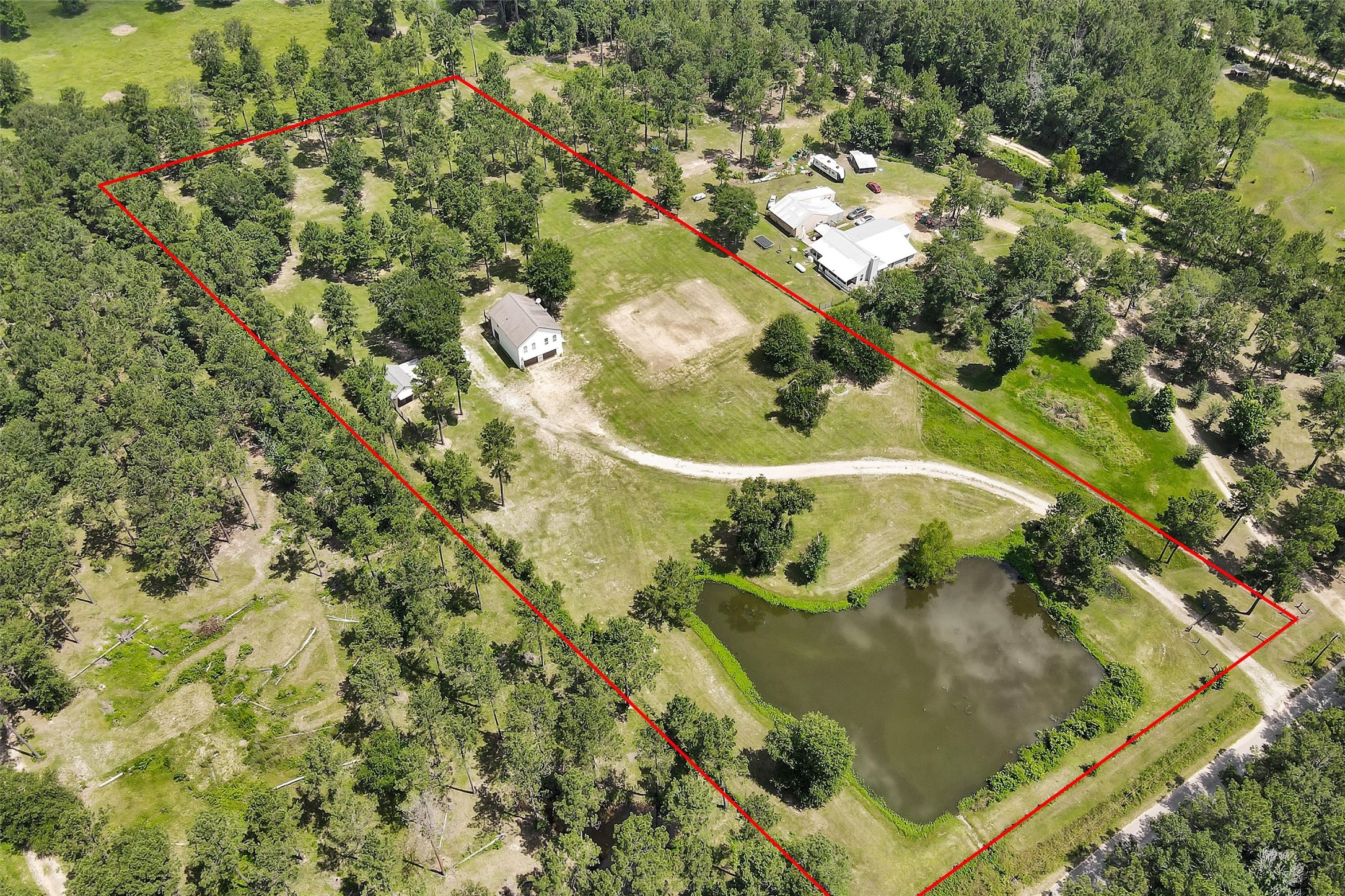 9321 North Walker Road Cleveland, TX 77328 - Photo 1 of 49 5 ACRE Property w/home, stocked pond, horse stall/barn, Generator, Well, Septic, RV Hook ups, Huge Garage w/AC in Laundry, Flex Room & Storage, fenced & cross fenced w/beautiful shade trees