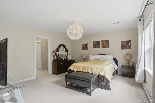 29 Hickory Hill Road Newburgh, NY 12550 - Photo 29 of 47 a bed sitting in a bedroom next to a window and a flat screen tv