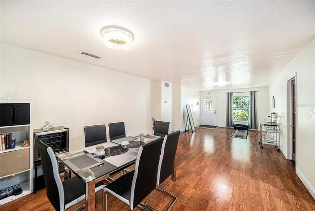 a view of a workspace with furniture and wooden floor