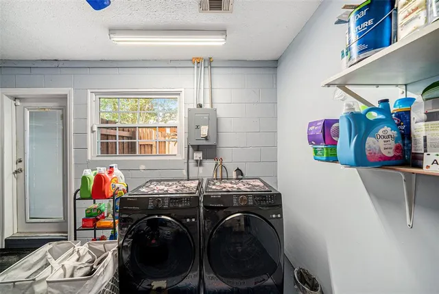 a utility room with dryer washer and other items