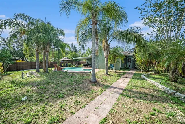 a view of a yard with palm trees