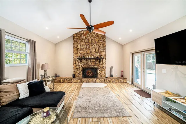a living room with fireplace furniture and a flat screen tv