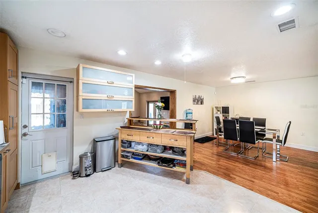 a living room with furniture pool table table and chairs