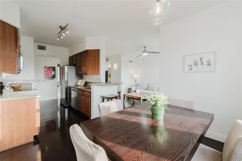 a dining room with furniture and a kitchen view