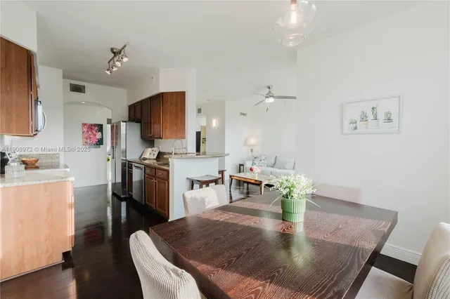a dining room with furniture and a kitchen view