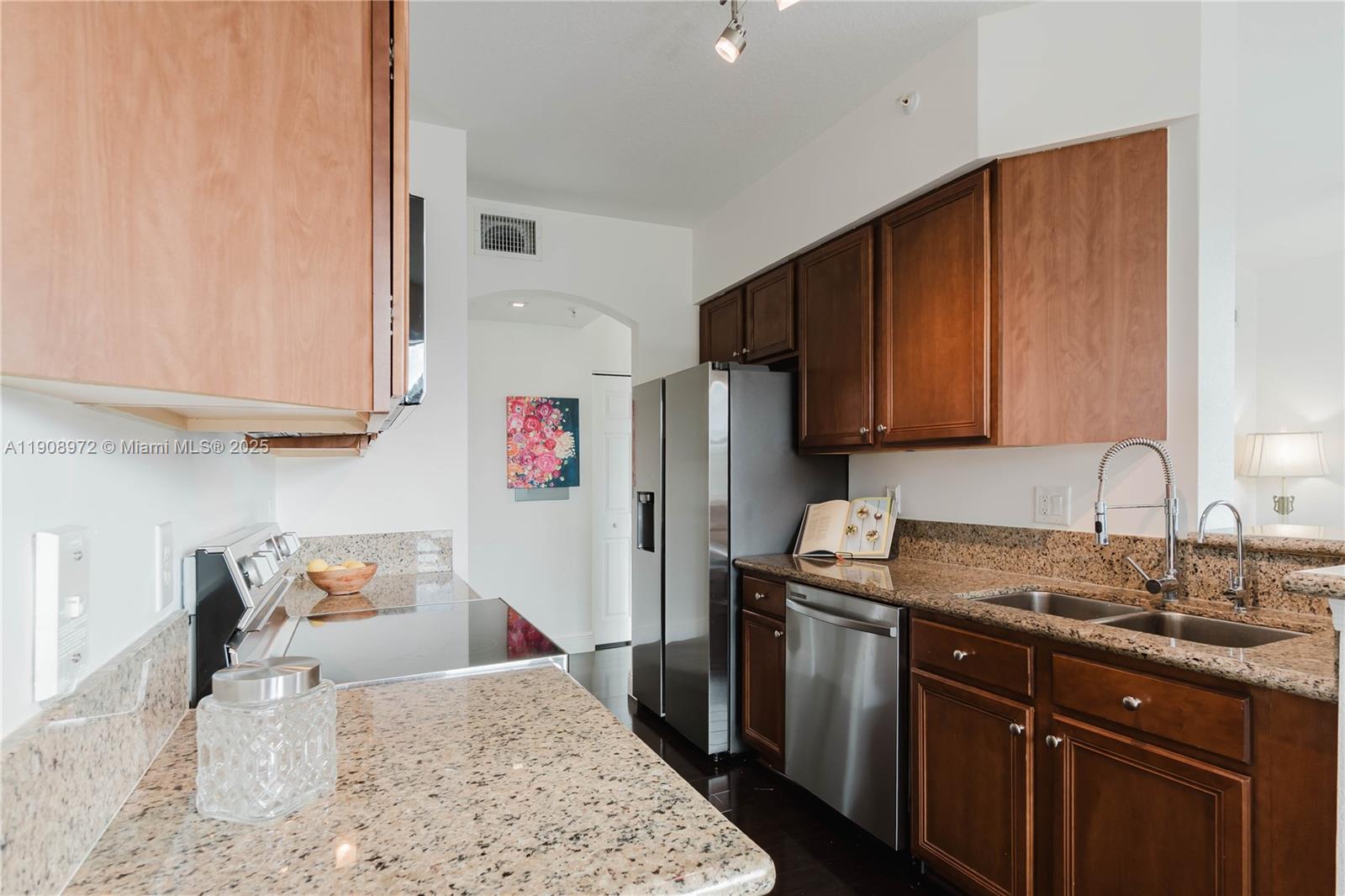9021 Southwest 94th Street, Unit 307 Miami, FL 33176 - Photo 4 of 18 a kitchen with stainless steel appliances granite countertop a sink stove and refrigerator