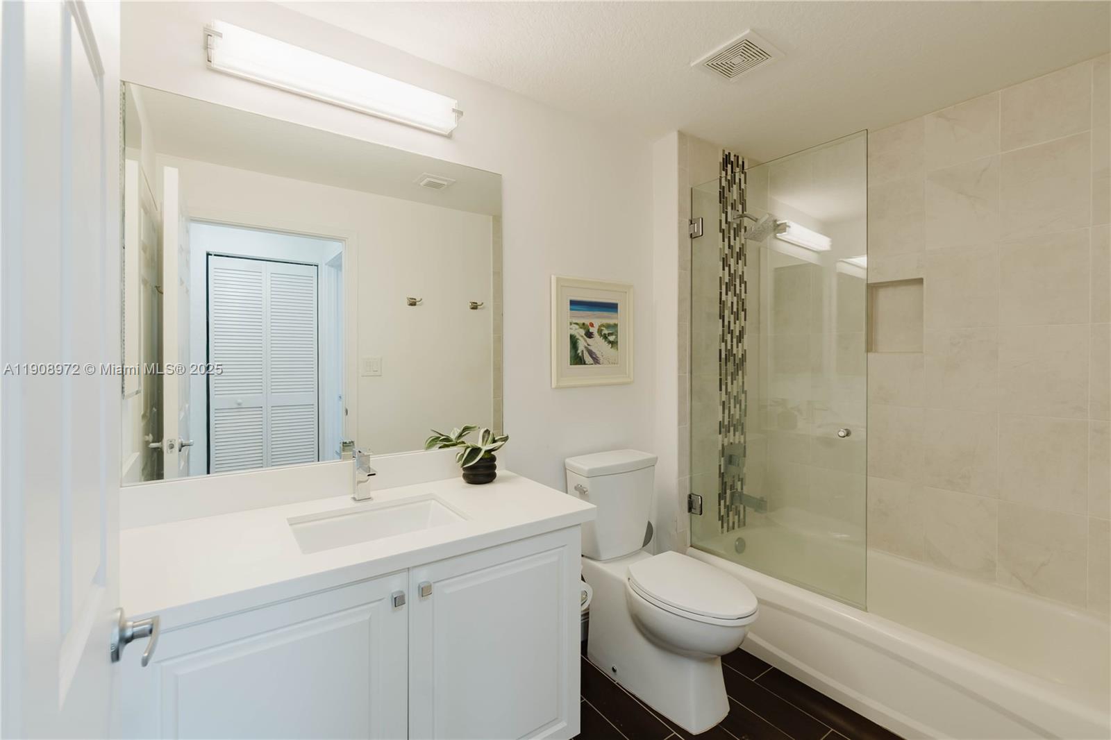 9021 Southwest 94th Street, Unit 307 Miami, FL 33176 - Photo 6 of 18 a bathroom with a sink a toilet and shower