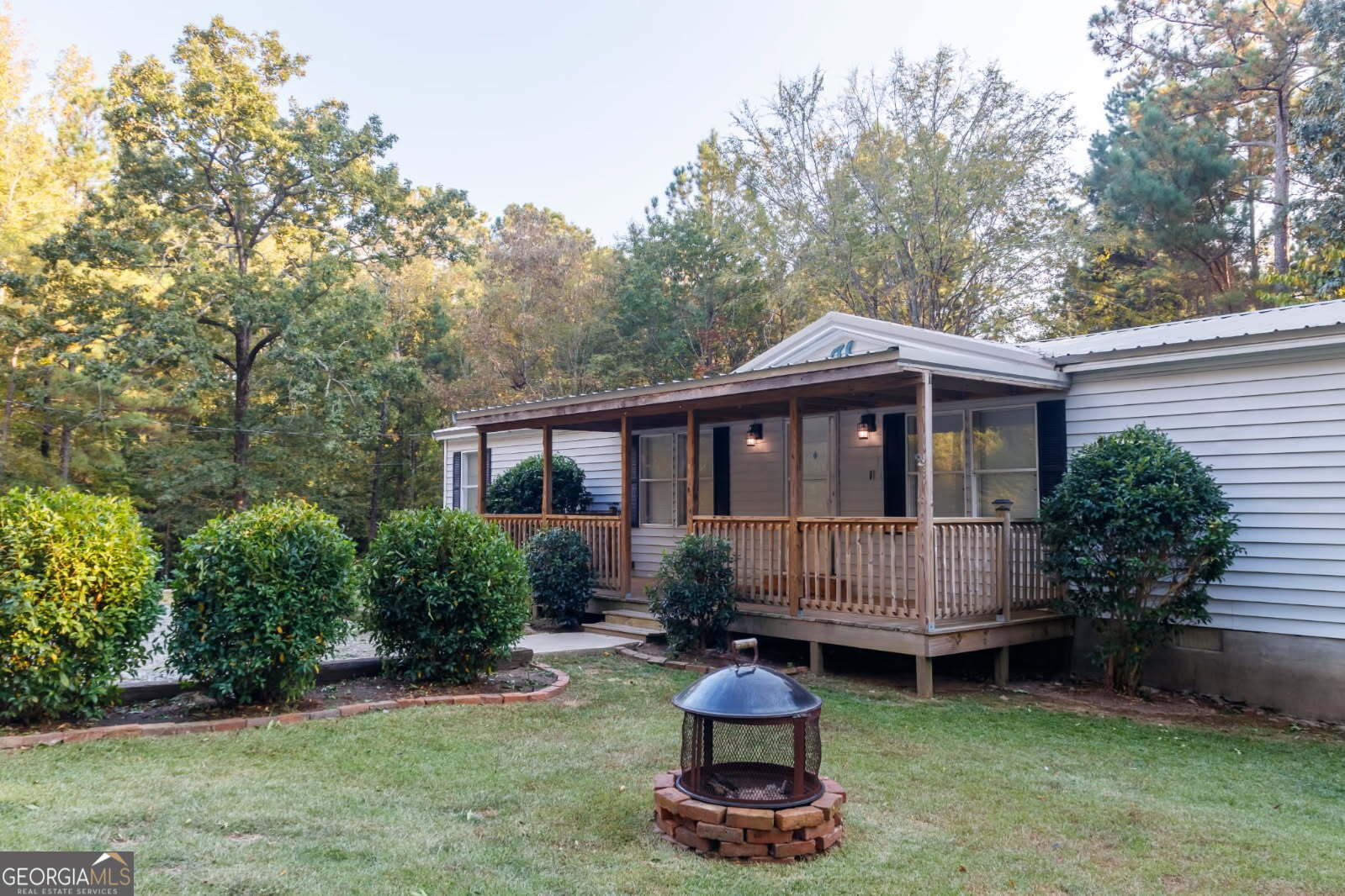 a view of a house with a yard and sitting area