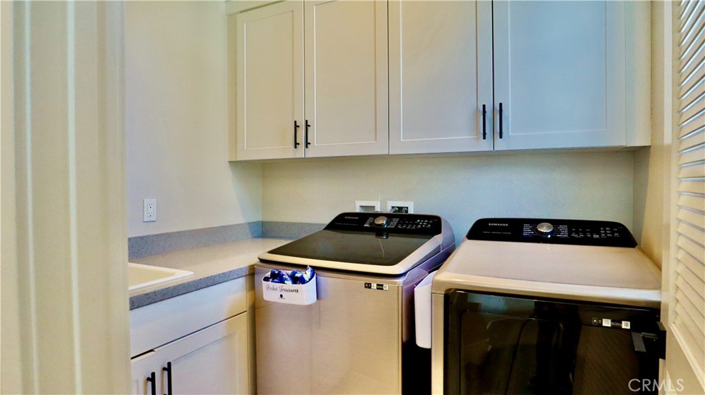 2180 Pearl Walk Gardena, CA 90249 - Photo 11 of 23 a kitchen with a sink a stove and cabinets