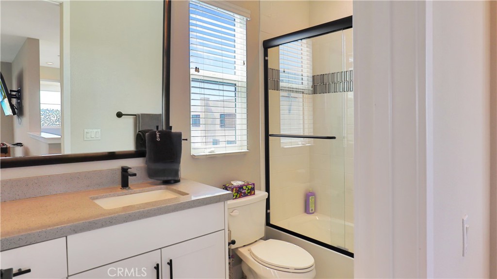 2180 Pearl Walk Gardena, CA 90249 - Photo 12 of 23 a bathroom with a granite countertop sink toilet and mirror