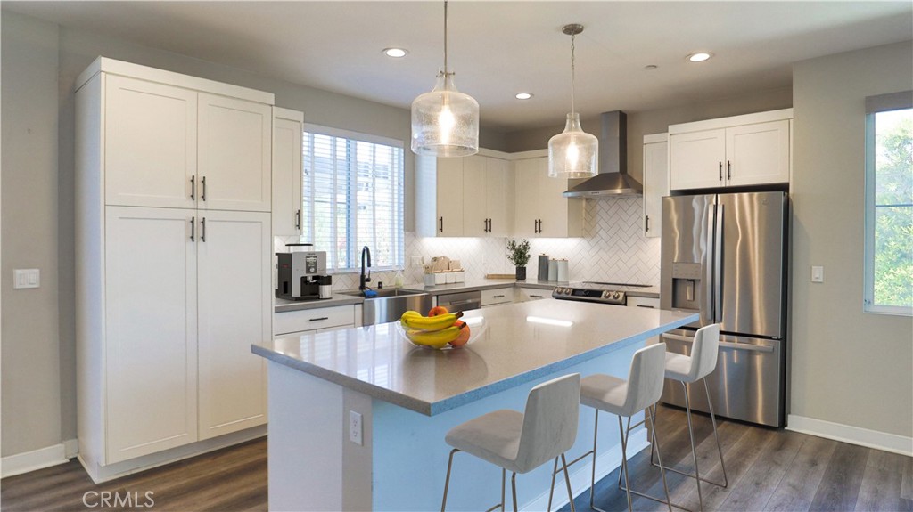 2180 Pearl Walk Gardena, CA 90249 - Photo 3 of 23 a kitchen with a sink a counter space and stainless steel appliances
