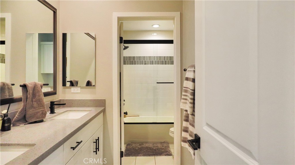2180 Pearl Walk Gardena, CA 90249 - Photo 8 of 23 a bathroom with a double vanity sink and mirror
