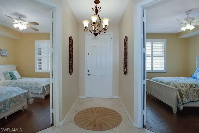 a bedroom with a bed and a chandelier