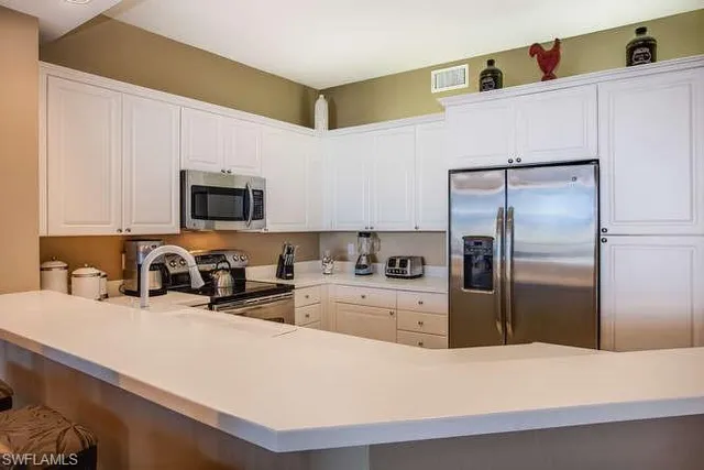 a kitchen with a refrigerator and a sink