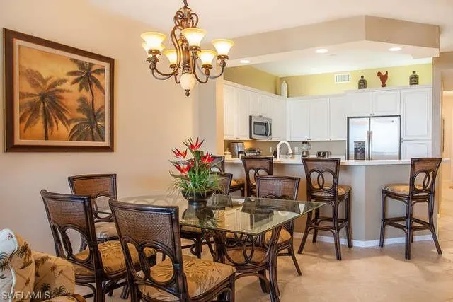 a view of a dining room with furniture and a chandelier