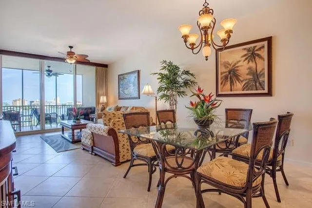 a view of a dining room with furniture and chandelier