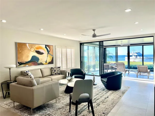 a living room with furniture and large windows