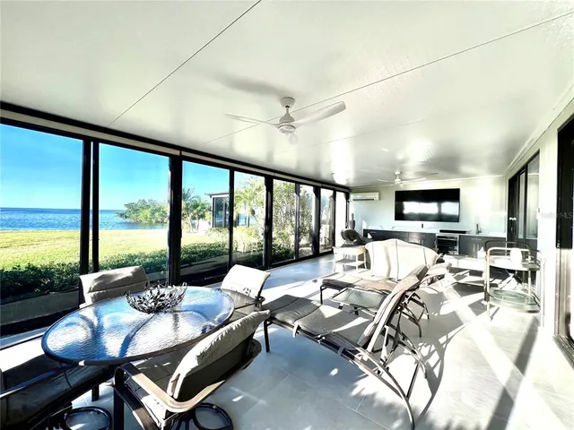 a living room with furniture and large windows