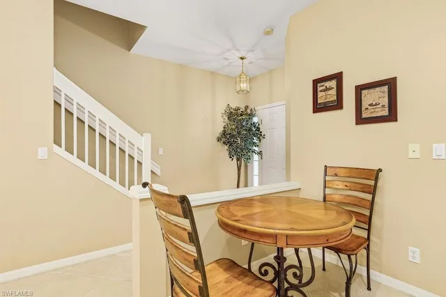 a view of a dining room with furniture and a chandelier
