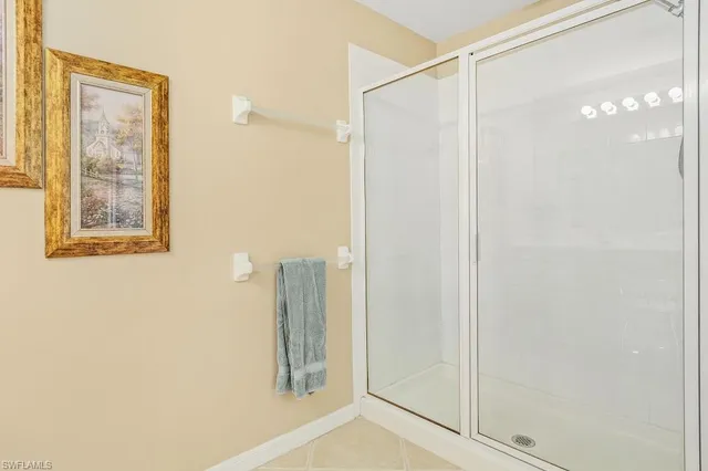 a bathroom with a shower and a mirror