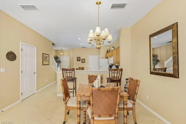 a view of a dining room with furniture and chandelier