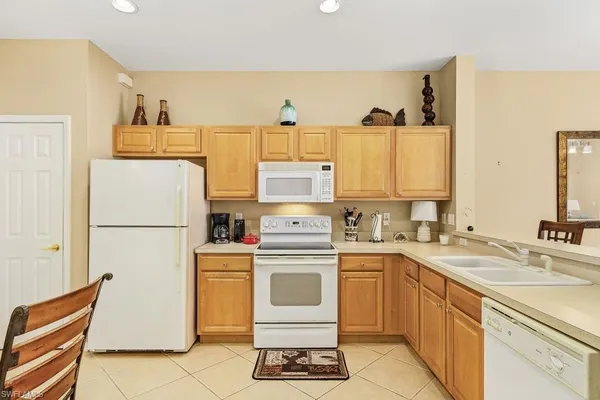 a kitchen with a white cabinets and white appliances