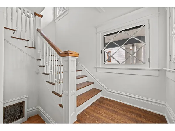 a view of entryway and hall with wooden floor