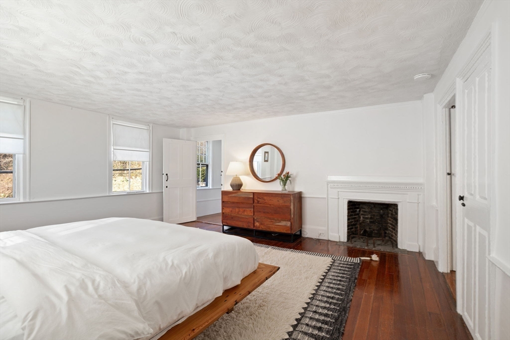 118 Main Street Sandwich, MA 02563 - Photo 25 of 41 a bedroom with a bed and a fireplace
