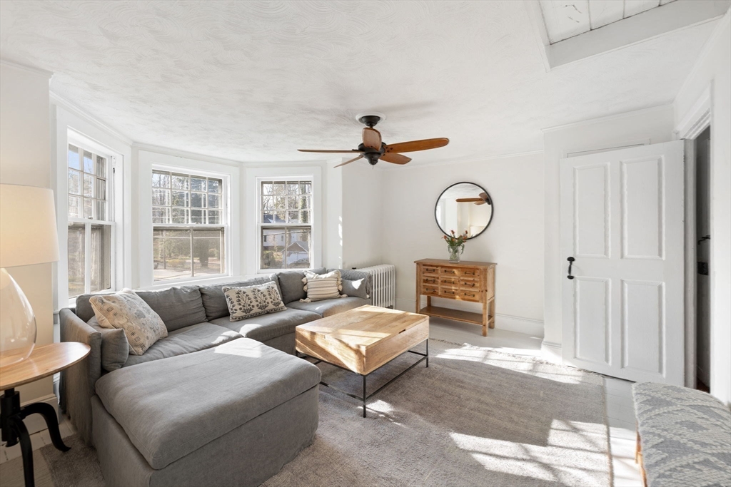 118 Main Street Sandwich, MA 02563 - Photo 27 of 41 a living room with furniture a clock and a window