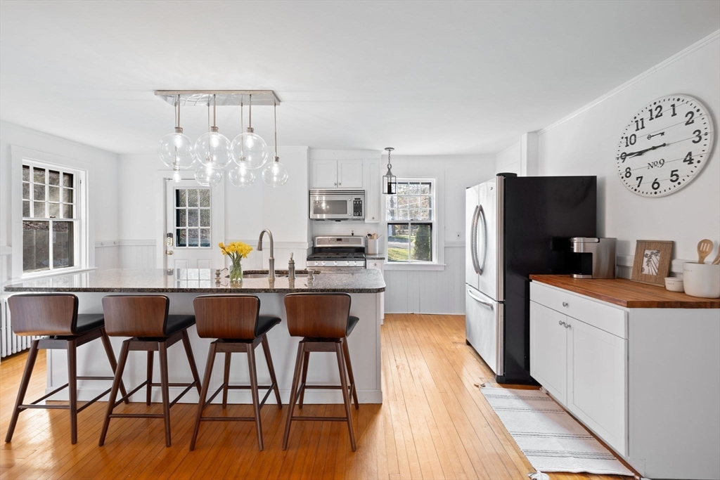 118 Main Street Sandwich, MA 02563 - Photo 3 of 41 a kitchen with stainless steel appliances a dining table chairs refrigerator and sink