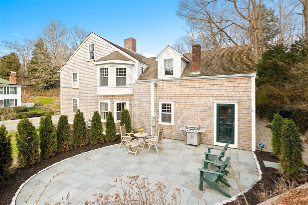 118 Main Street Sandwich, MA 02563 - Photo 36 of 41 a view of a white house with a chairs in patio