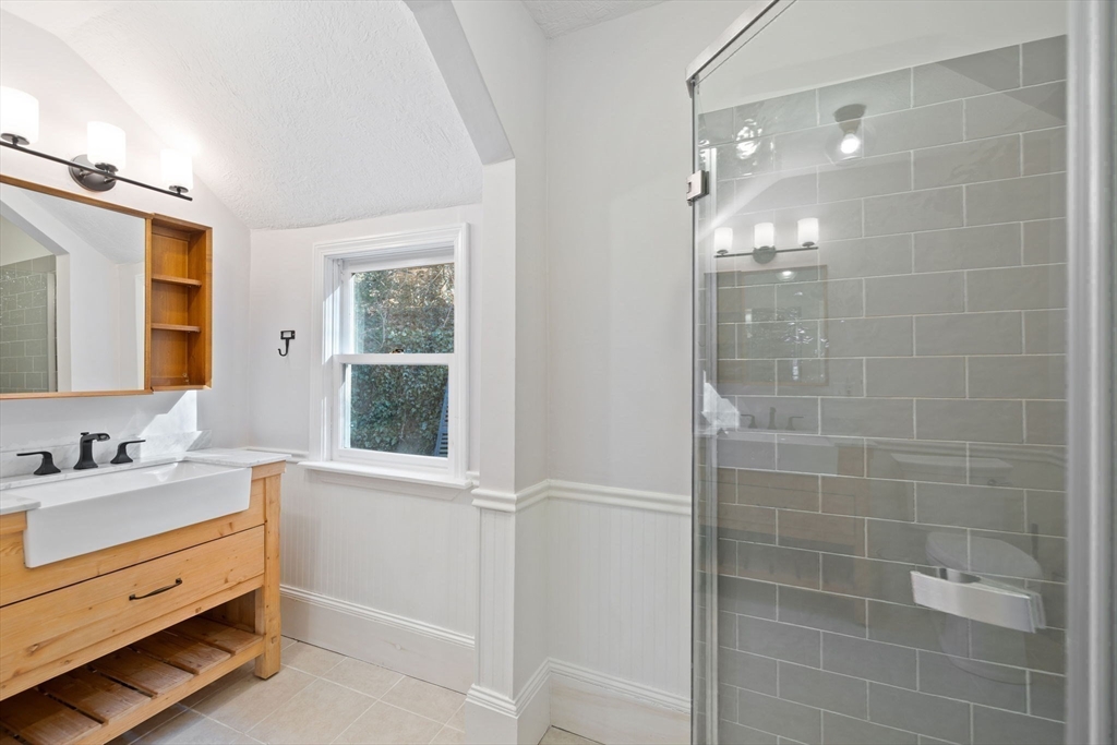 118 Main Street Sandwich, MA 02563 - Photo 8 of 41 a bathroom with a double vanity sink a mirror and a shower