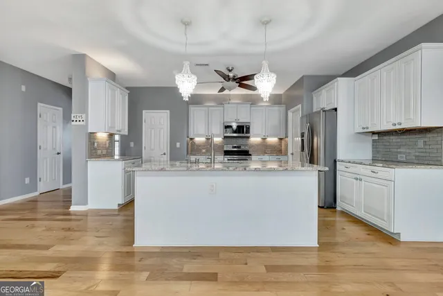 a bathroom with a granite countertop toilet sink and shower