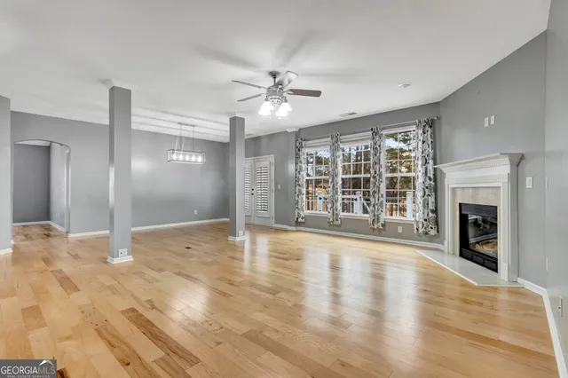 a view of a livingroom with a ceiling fan and window