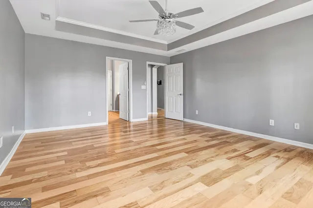 a view of a hallway with wooden floor