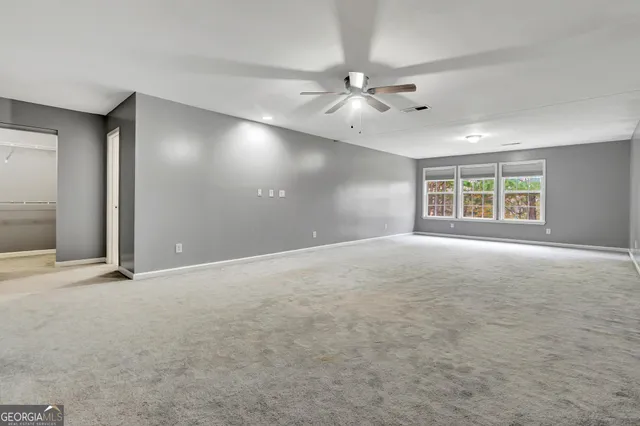 a view of walk in closet with empty racks