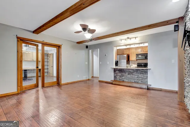 a view of a balcony with wooden floor and fence
