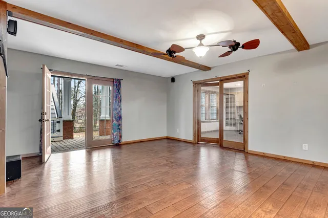 a view of a big house with a big yard and large trees