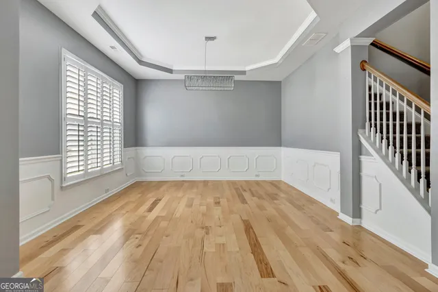 a kitchen with granite countertop a sink a counter top space stainless steel appliances and a chandelier