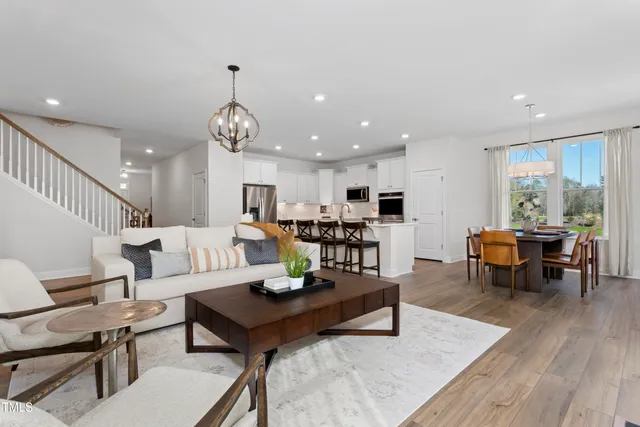 a living room with furniture kitchen view and a dining table