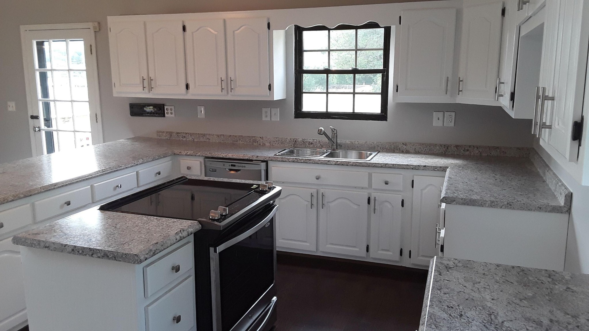 129 Rosedale Avenue Rutledge, TN 37861 - Photo 12 of 34 a kitchen with granite countertop a sink stove and cabinets