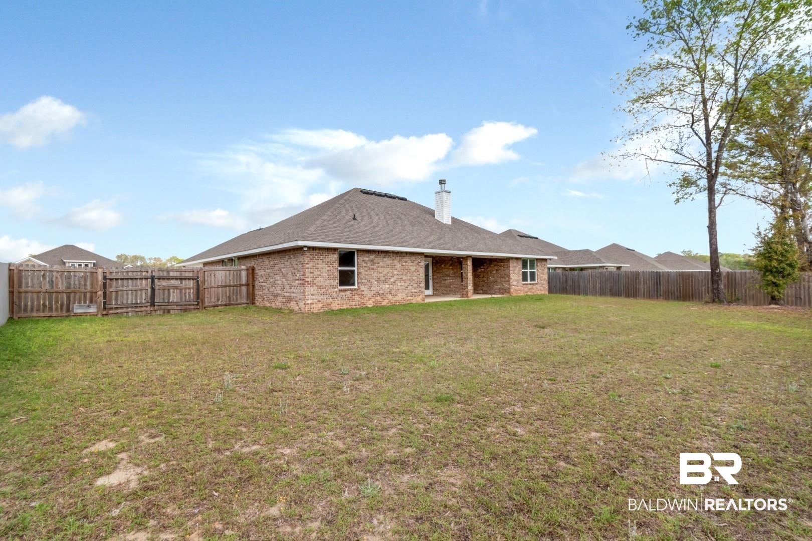 6632 Monarch Circle Mobile, AL 36618 - Photo 28 of 32 Back of house with a fenced backyard, a patio area, brick siding, and a chimney