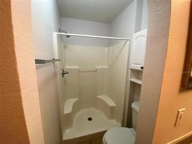 a bathroom with a shower and toilet